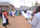 PICTURES: NRM members from Nabukalu Zone, Bwaise 2 Parish in Kawempe Division attending a Village Baraza to verify and confirm LCI chairperson and Women council  Flagbearers.